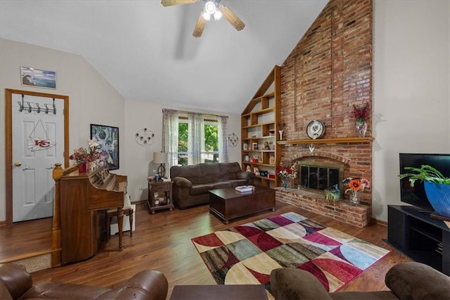 9111 Allman Rd, Lenexa, KS 66219 - living room with lofted ceiling, wood finished floors, a ceiling fan, a fireplace, and built in shelves
