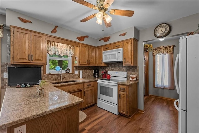 9111 Allman Rd, Lenexa, KS 66219 - kitchen with white appliances, wood finished floors, light stone countertops, and decorative backsplash
