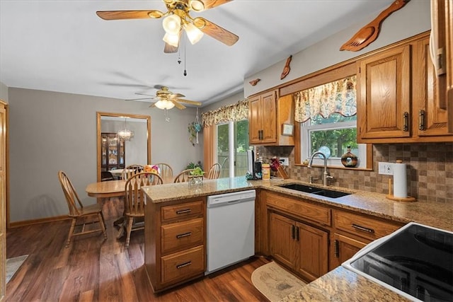 9111 Allman Rd, Lenexa, KS 66219 - kitchen with white dishwasher, brown cabinets, stove, a ceiling fan, and a peninsula