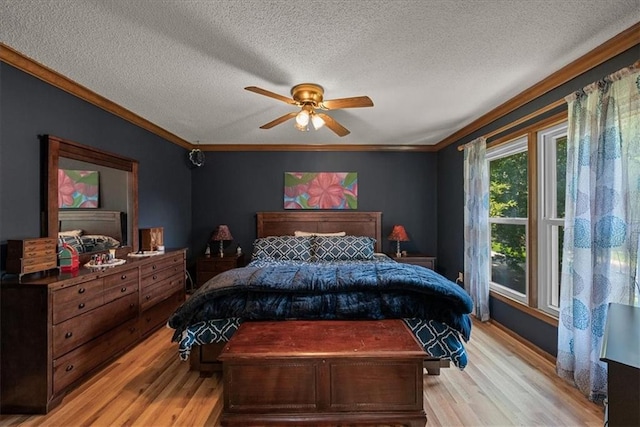 9111 Allman Rd, Lenexa, KS 66219 - bedroom with light wood-style flooring, crown molding, a textured ceiling, and ceiling fan