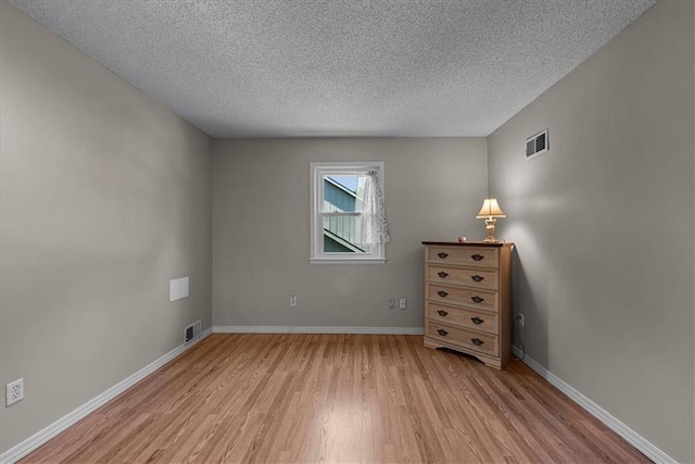 9111 Allman Rd, Lenexa, KS 66219 - unfurnished bedroom featuring light wood finished floors and a textured ceiling