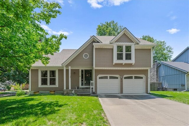 9111 Allman Rd, Lenexa, KS 66219 - traditional-style home featuring a front yard, driveway, an attached garage, and a shingled roof