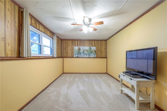 unfurnished living room featuring carpet flooring, ceiling fan, and baseboards