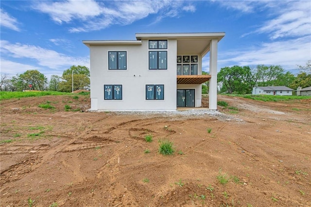 back of property featuring stucco siding