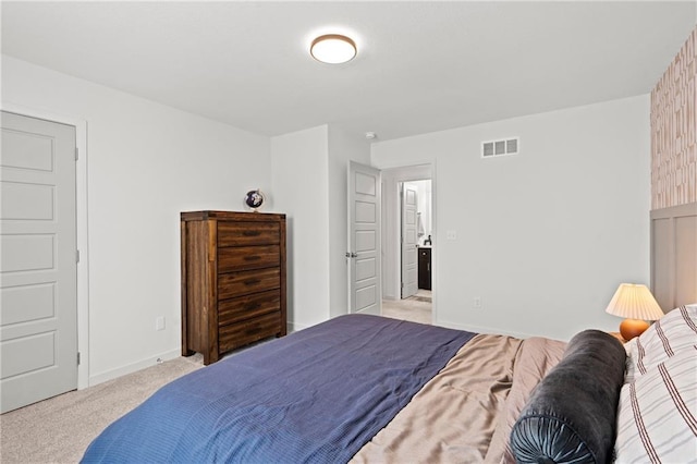 bedroom with baseboards, visible vents, and light colored carpet