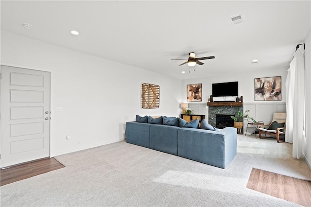 living area with recessed lighting, carpet, visible vents, a glass covered fireplace, and ceiling fan