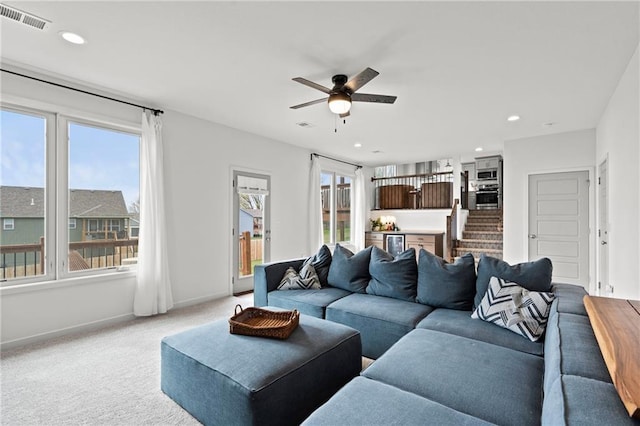 living room with a ceiling fan, light carpet, baseboards, visible vents, and recessed lighting