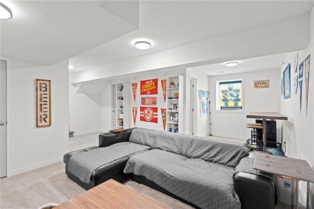 carpeted living room featuring baseboards and a textured ceiling