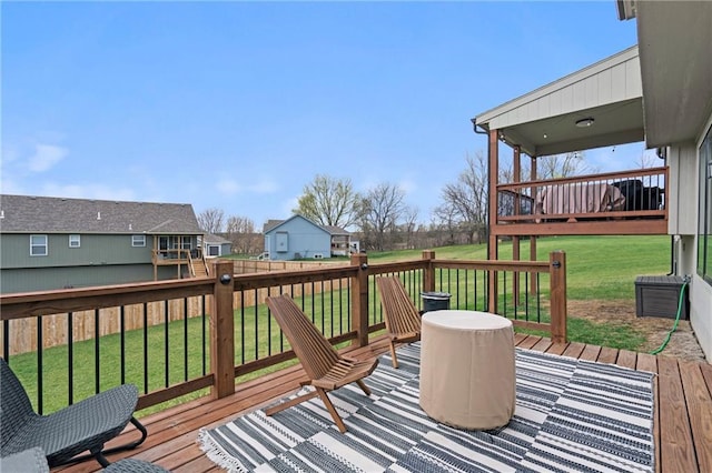 wooden terrace featuring a yard