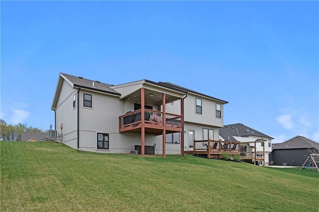 back of property with a yard and a wooden deck