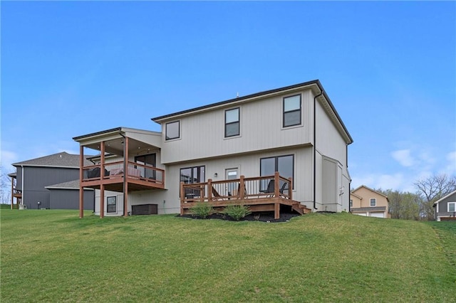 back of property with a lawn and a deck