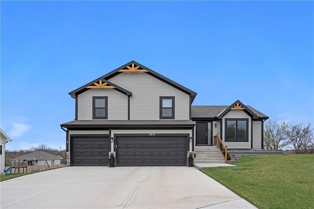 view of front of home featuring a front lawn, driveway, and an attached garage