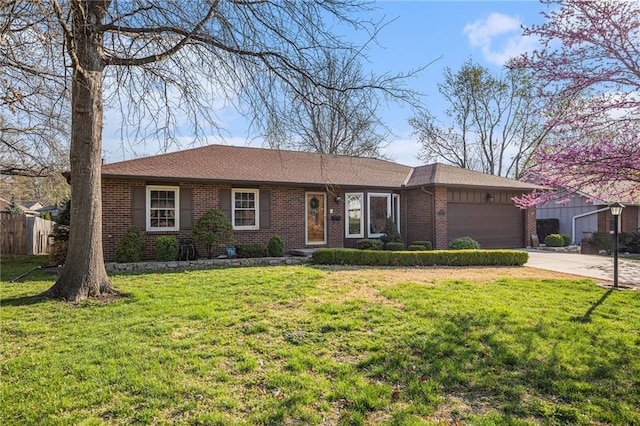 ranch-style home with an attached garage, fence, brick siding, a front lawn, and driveway