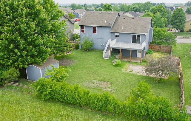 953 N Hickory Dr, Tonganoxie, KS 66086 - back of property featuring a shingled roof, a deck, and stairs