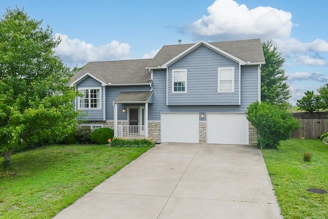 953 N Hickory Dr, Tonganoxie, KS 66086 - view of front of house featuring a garage, driveway, a shingled roof, and stone siding