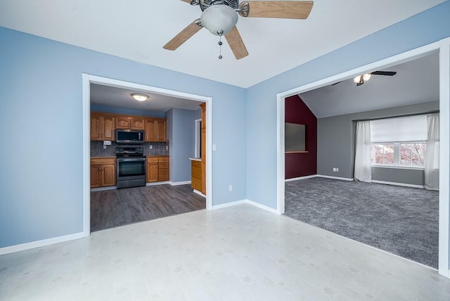 953 N Hickory Dr, Tonganoxie, KS 66086 - unfurnished living room with a ceiling fan, baseboards, carpet flooring, and lofted ceiling