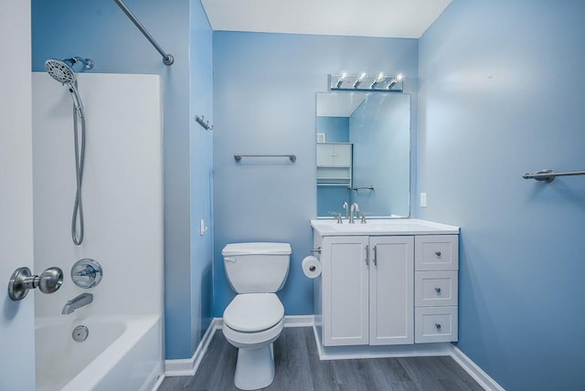 953 N Hickory Dr, Tonganoxie, KS 66086 - bathroom with wood finished floors, vanity, baseboards, toilet, and shower / tub combination