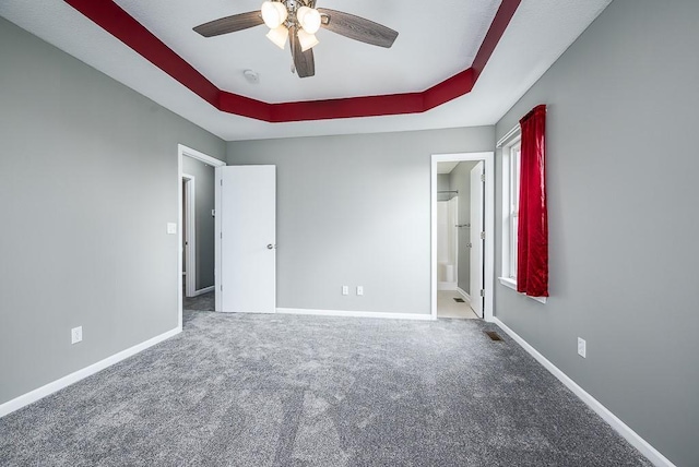 953 N Hickory Dr, Tonganoxie, KS 66086 - unfurnished bedroom featuring carpet floors, a tray ceiling, and baseboards