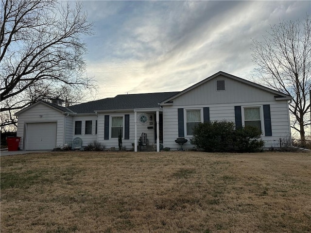 single story home featuring an attached garage and a front lawn