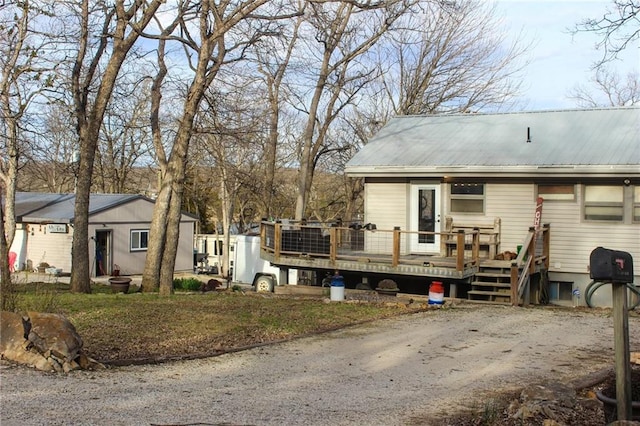 exterior space with a deck and metal roof