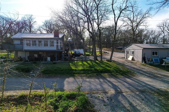 exterior space featuring metal roof and a chimney