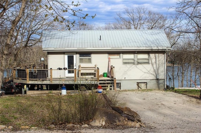 view of front of home with a wooden deck and metal roof