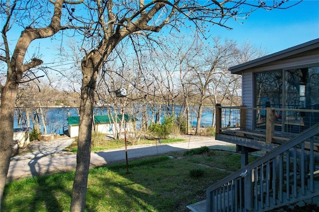 view of yard featuring a deck with water view