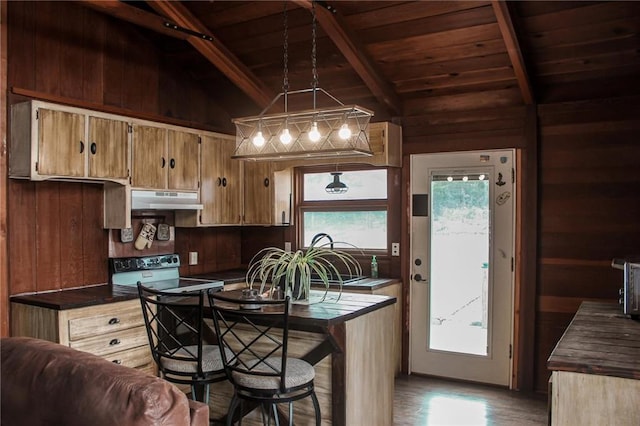 kitchen featuring lofted ceiling with beams, dark countertops, under cabinet range hood, range with electric stovetop, and wooden ceiling