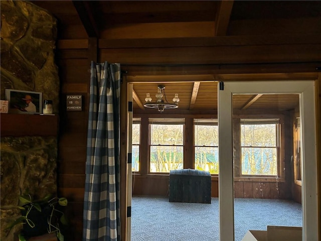 interior space featuring a chandelier and carpet floors