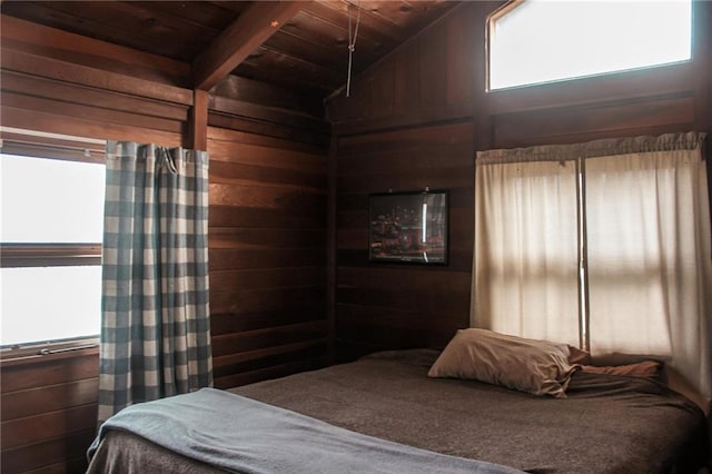 bedroom featuring wooden walls, vaulted ceiling with beams, and wood ceiling