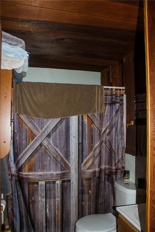 full bathroom with vanity, wood ceiling, and toilet