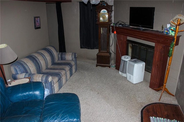 living room featuring carpet and concrete block wall