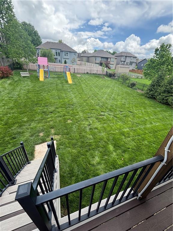 903 Chisam Rd, Kearney, MO 64060 - view of yard featuring a playground, fence, and a residential view
