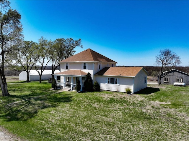 2023 Linden Rd, Hiawatha, KS 66434 - back of property featuring a lawn, covered porch, and roof with shingles