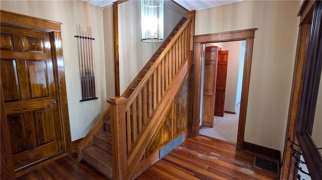 2023 Linden Rd, Hiawatha, KS 66434 - stairs featuring baseboards, wood finished floors, a chandelier, and visible vents