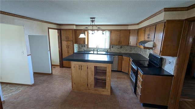 2023 Linden Rd, Hiawatha, KS 66434 - kitchen with crown molding, dark countertops, appliances with stainless steel finishes, and decorative backsplash