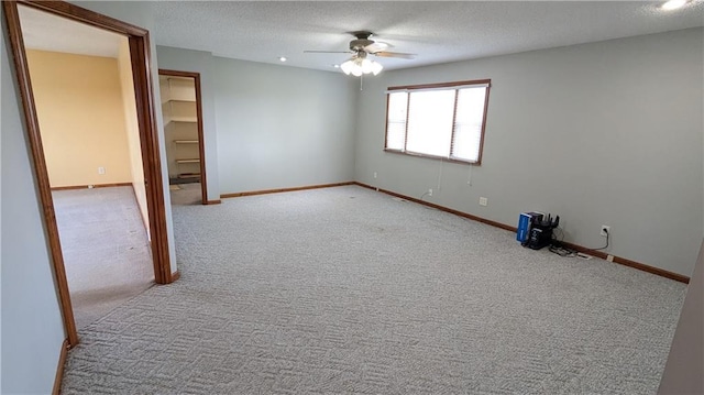 2023 Linden Rd, Hiawatha, KS 66434 - carpeted empty room featuring ceiling fan, baseboards, and a textured ceiling
