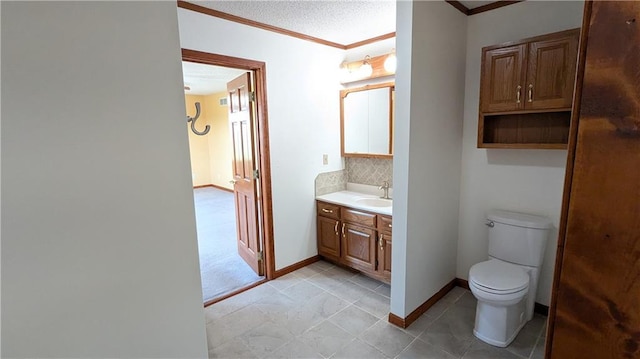 2023 Linden Rd, Hiawatha, KS 66434 - bathroom featuring crown molding, vanity, baseboards, backsplash, and toilet