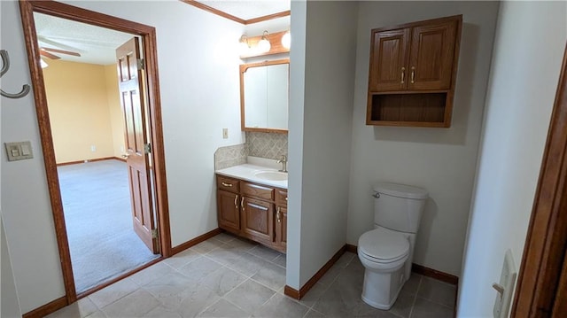 2023 Linden Rd, Hiawatha, KS 66434 - bathroom featuring baseboards, vanity, backsplash, and toilet