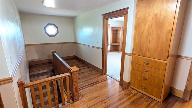 2023 Linden Rd, Hiawatha, KS 66434 - staircase with hardwood / wood-style floors and wainscoting