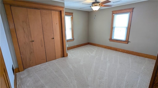 2023 Linden Rd, Hiawatha, KS 66434 - unfurnished bedroom with visible vents, baseboards, light colored carpet, a closet, and ornamental molding