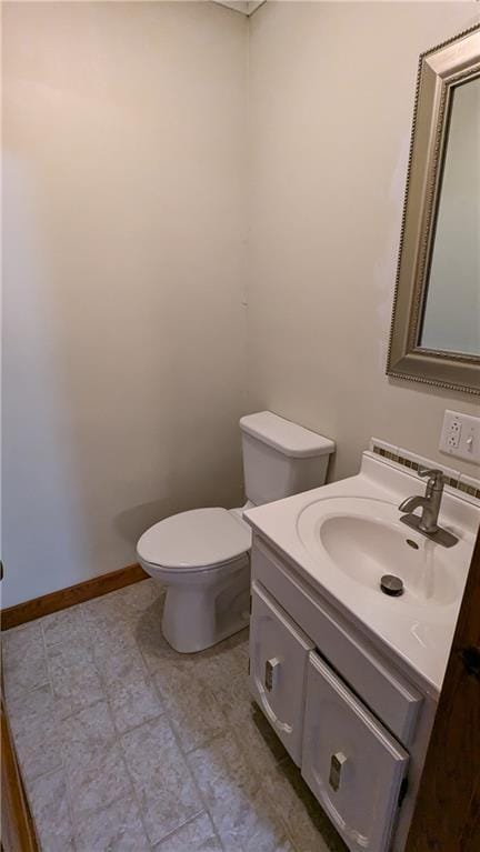 2023 Linden Rd, Hiawatha, KS 66434 - half bathroom with baseboards, vanity, and toilet
