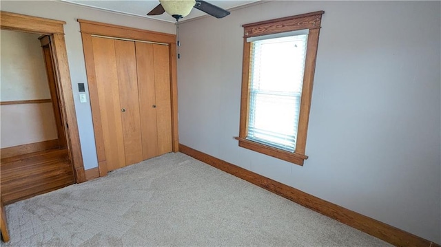 2023 Linden Rd, Hiawatha, KS 66434 - unfurnished bedroom with baseboards, carpet floors, ceiling fan, and a closet