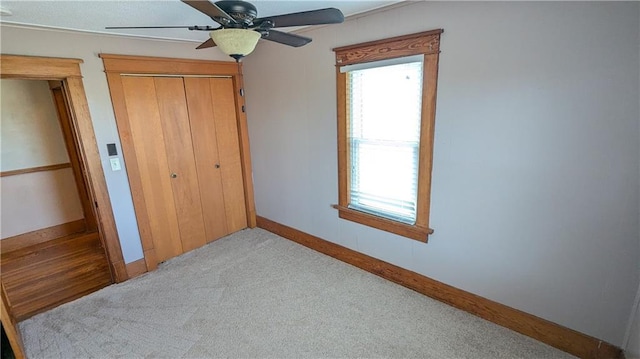 2023 Linden Rd, Hiawatha, KS 66434 - unfurnished bedroom with carpet, a closet, a ceiling fan, and baseboards