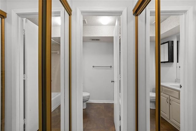 full bathroom with toilet, vanity, a bathtub, a textured ceiling, and a shower