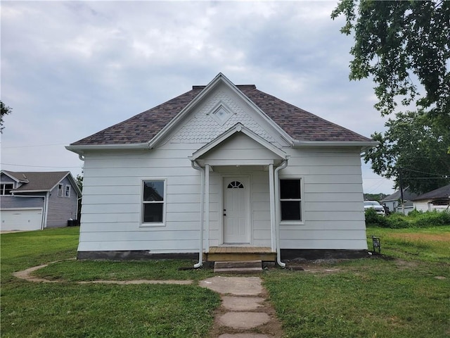 6211 Washington St, Saint Joseph, MO 64504 - bungalow-style home with a front yard and roof with shingles