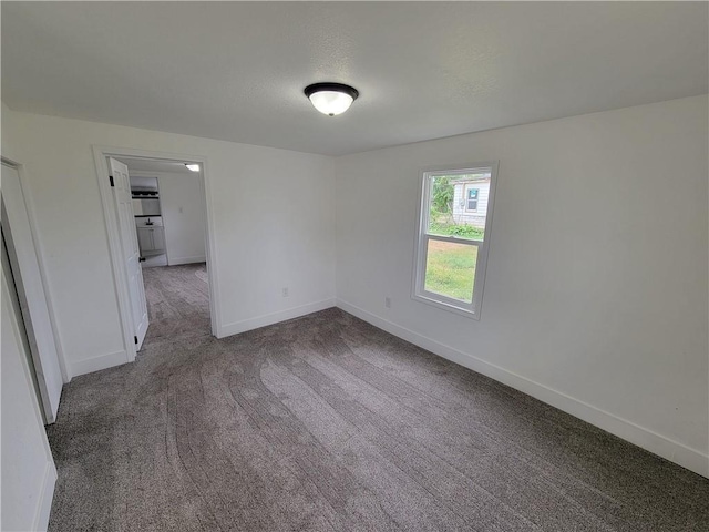 6211 Washington St, Saint Joseph, MO 64504 - unfurnished room with baseboards, carpet, and a textured ceiling