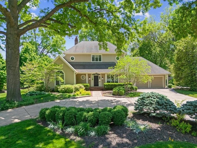2901 W 69th St, Mission Hills, KS 66208 - traditional home featuring a chimney, a garage, and concrete driveway