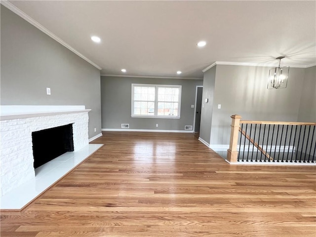 unfurnished living room with recessed lighting, baseboards, light wood-style floors, a notable chandelier, and a fireplace