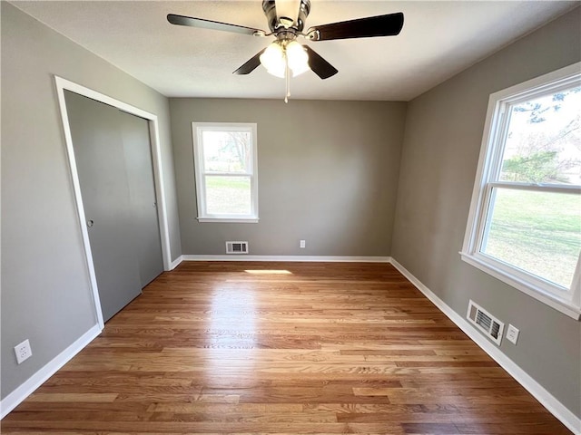 unfurnished bedroom featuring baseboards, visible vents, and light wood-type flooring